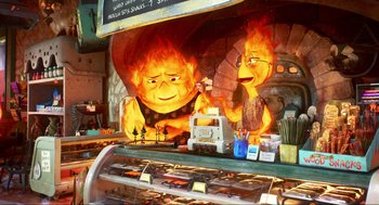 Movie still from “Elemental” (2023), directed by Peter Sohn – A display in a store with a fire burning on it's face; Medium shot, Over the shoulder angle