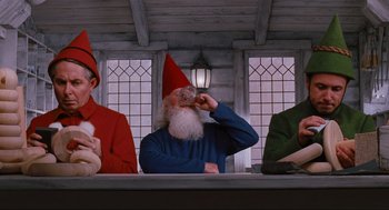 Movie still from “Elf” (2003), directed by Jon Favreau – A group of people sitting at a table; Medium shot, Low angle
