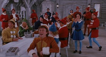 Movie still from “Elf” (2003), directed by Jon Favreau – A group of people dressed as snow white and seven dwarfs; Wide shot, High angle