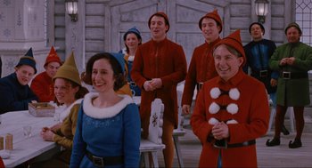 Movie still from “Elf” (2003), directed by Jon Favreau – A group of people dressed as elves standing next to each other; Medium shot, Over the shoulder angle