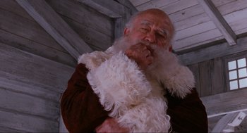 Movie still from “Elf” (2003), directed by Jon Favreau – An old man dressed as santa claus with a white beard; Close Up shot, Low angle