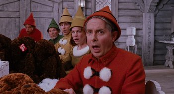 Movie still from “Elf” (2003), directed by Jon Favreau – A group of people dressed in elf costumes; Medium shot, Low angle