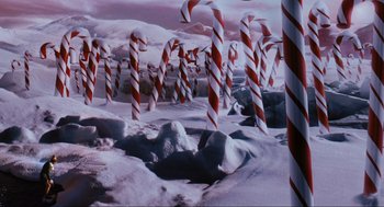 Movie still from “Elf” (2003), directed by Jon Favreau – A bunch of red and white candy canes in the snow; Extreme Wide shot, High angle