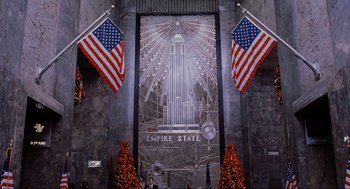 Movie still from “Elf” (2003), directed by Jon Favreau – A picture of the empire state building in new york city; Extreme Wide shot, Low angle
