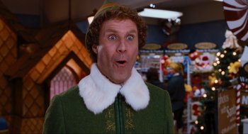 Movie still from “Elf” (2003), directed by Jon Favreau – A person wearing a suit and hat; Close Up shot, Low angle