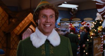 Movie still from “Elf” (2003), directed by Jon Favreau – A person wearing a elf costume; Medium shot, Low angle