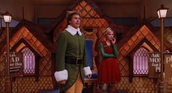 Movie still from “Elf” (2003), directed by Jon Favreau – A man and a woman dressed up as a christmas elf and a girl dressed up as a princess; Medium shot, Low angle