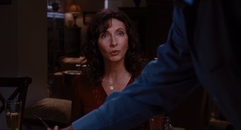 Movie still from “Elf” (2003), directed by Jon Favreau – A woman sitting in front of a man in front of a table; Close Up shot, Over the shoulder angle