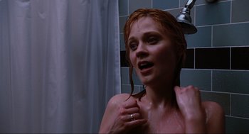 Movie still from “Elf” (2003), directed by Jon Favreau – A woman is taking a shower in a bathroom; Close Up shot, Low angle