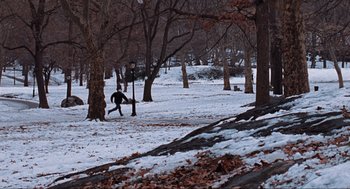 Movie still from “Elf” (2003), directed by Jon Favreau – A man running in the snow in a park; Extreme Wide shot, High angle