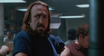 Movie still from “Elf” (2003), directed by Jon Favreau – A person with long hair and a beard; Close Up shot, Low angle