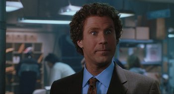 Movie still from “Elf” (2003), directed by Jon Favreau – A person wearing a suit and tie; Close Up shot, Over the shoulder angle