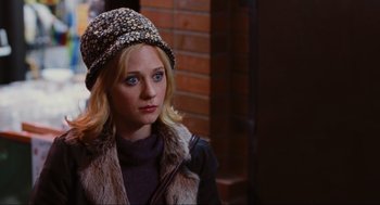 Movie still from “Elf” (2003), directed by Jon Favreau – A woman wearing a hat and a fur coat; Close Up shot, Over the shoulder angle