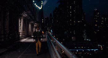 Movie still from “Elf” (2003), directed by Jon Favreau – A man walking on a bridge at night; Extreme Wide shot, Low angle