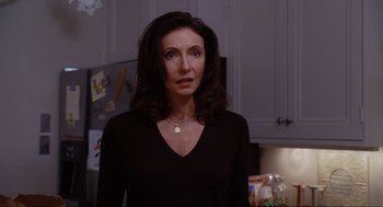 Movie still from “Elf” (2003), directed by Jon Favreau – A woman standing in front of a refrigerator in a kitchen; Close Up shot, Over the shoulder angle