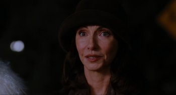 Movie still from “Elf” (2003), directed by Jon Favreau – A person wearing a hat and looking at the camera; Close Up shot, Over the shoulder angle