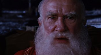 Movie still from “Elf” (2003), directed by Jon Favreau – An old man with a long white beard; Extreme Close Up shot, Over the shoulder angle