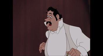 Movie still from “Elizabeth: A Portrait in Part(s)” (2022), directed by Roger Michell – A man in a white shirt and a bow tie; Close Up shot, Low angle