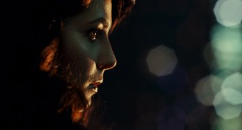 Movie still from “A Good Day to Die Hard” (2013), directed by John Moore – A woman's face in the dark; Extreme Close Up shot, Low angle