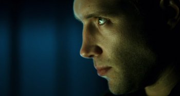 Movie still from “A Good Day to Die Hard” (2013), directed by John Moore – A man's face in a dark room; Extreme Close Up shot, Low angle