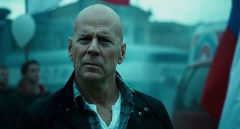 Movie still from “A Good Day to Die Hard” (2013), directed by John Moore – A bald man in a black jacket and a white shirt; Close Up shot, Low angle