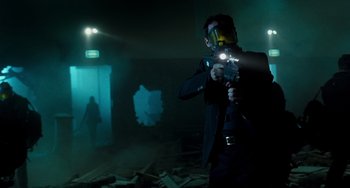 Movie still from “A Good Day to Die Hard” (2013), directed by John Moore – A man holding a gun while wearing a mask and holding a flashlight; Medium shot, Low angle