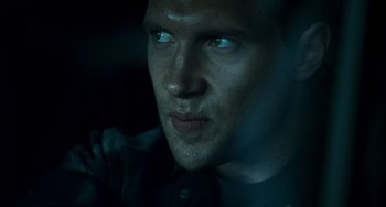 Movie still from “A Good Day to Die Hard” (2013), directed by John Moore – A man's face in the dark; Close Up shot, Low angle
