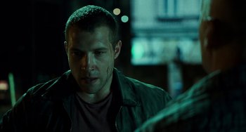 Movie still from “A Good Day to Die Hard” (2013), directed by John Moore – A person wearing a green jacket; Close Up shot, Over the shoulder angle