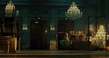 Movie still from “A Good Day to Die Hard” (2013), directed by John Moore – A chandelier hangs in the middle of a room; Wide shot, Low angle