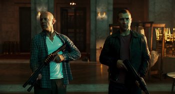 Movie still from “A Good Day to Die Hard” (2013), directed by John Moore – A couple of men standing next to each other holding guns; Medium shot, Low angle