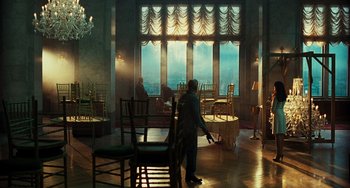 Movie still from “A Good Day to Die Hard” (2013), directed by John Moore – A man sweeping the floor of a room with chairs in front of him; Wide shot, High angle