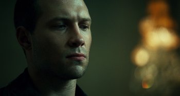 Movie still from “A Good Day to Die Hard” (2013), directed by John Moore – A man's face in a dark room; Close Up shot, Low angle