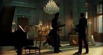 Movie still from “A Good Day to Die Hard” (2013), directed by John Moore – A man is standing in the middle of an empty room; Wide shot, Low angle