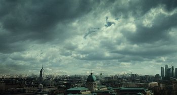 Movie still from “A Good Day to Die Hard” (2013), directed by John Moore – A view of a city with a cloudy sky above it; Extreme Wide shot, Low angle