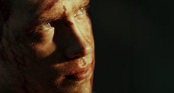 Movie still from “A Good Day to Die Hard” (2013), directed by John Moore – A man's face with blood all over his face; Extreme Close Up shot, Low angle