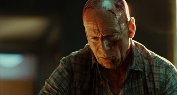 Movie still from “A Good Day to Die Hard” (2013), directed by John Moore – A bald man with blood all over his face; Close Up shot, Low angle