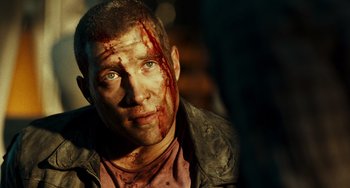 Movie still from “A Good Day to Die Hard” (2013), directed by John Moore – A person with blood on his face; Close Up shot, Over the shoulder angle