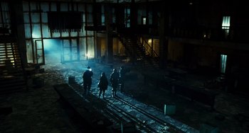 Movie still from “A Good Day to Die Hard” (2013), directed by John Moore – A group of people walking on a train track in the dark; Extreme Wide shot, Low angle