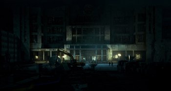 Movie still from “A Good Day to Die Hard” (2013), directed by John Moore – A construction site with a large building in the background at night; Extreme Wide shot, High angle