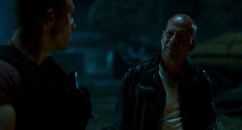 Movie still from “A Good Day to Die Hard” (2013), directed by John Moore – A man in a leather jacket talking to another man in a leather jacket; Close Up shot, Over the shoulder angle