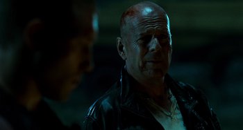 Movie still from “A Good Day to Die Hard” (2013), directed by John Moore – A man with a shaved head wearing a leather jacket; Close Up shot, Over the shoulder angle
