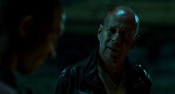 Movie still from “A Good Day to Die Hard” (2013), directed by John Moore – A man with a shaved head is looking at another man; Close Up shot, Over the shoulder angle