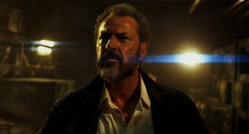 Movie still from “A Good Day to Die Hard” (2013), directed by John Moore – A man with a long beard and a white shirt; Close Up shot, Low angle
