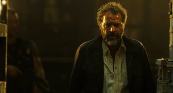 Movie still from “A Good Day to Die Hard” (2013), directed by John Moore – A man with a beard is standing in the dark; Close Up shot, Low angle