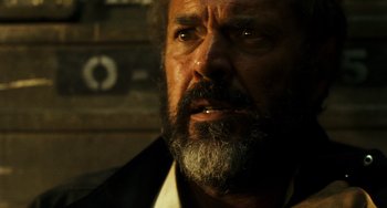 Movie still from “A Good Day to Die Hard” (2013), directed by John Moore – An old man with a beard and a mustache; Close Up shot, Over the shoulder angle