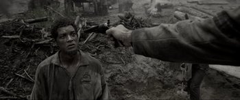 Movie still from “Emancipation” (2022), directed by Antoine Fuqua – A man standing next to a dead animal in the dirt; Close Up shot, Over the shoulder angle