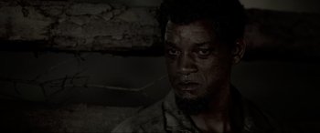 Movie still from “Emancipation” (2022), directed by Antoine Fuqua – A person with a beard looking at the camera; Close Up shot, Low angle