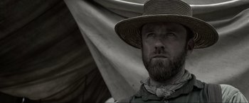 Movie still from “Emancipation” (2022), directed by Antoine Fuqua – A man with a beard wearing a straw hat; Close Up shot, Low angle