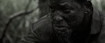 Movie still from “Emancipation” (2022), directed by Antoine Fuqua – A man's face covered in dirt; Extreme Close Up shot, Low angle