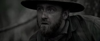 Movie still from “Emancipation” (2022), directed by Antoine Fuqua – A person wearing a hat; Close Up shot, Over the shoulder angle